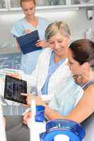 Patient at dental surgery dentist show xray tablet