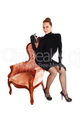 Woman sitting on armchair.