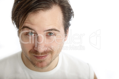 Attractive man in a white shirt looks into the camera