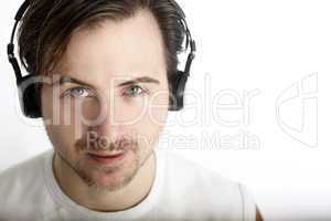 Attractive man with headphones looks into the camera