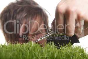 Young man cuts English lawn