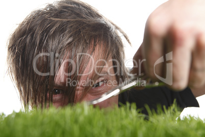 Young man cuts English lawn