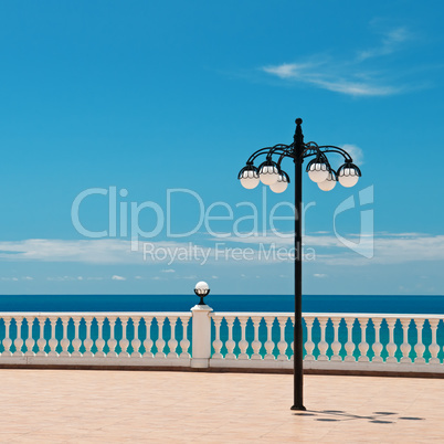 beautiful promenade with lanterns and white railings