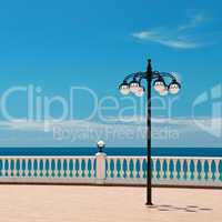 beautiful promenade with lanterns and white railings