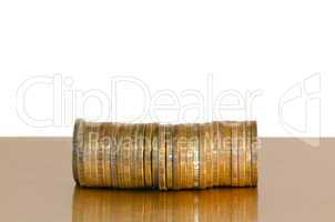 A stack of coins, placed horizontally on a white background