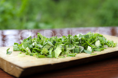 Chopped green onions on a cutting Board