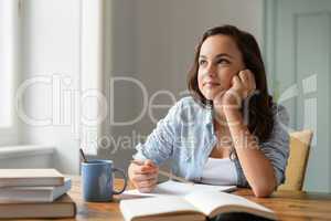 Student teenage girl studying at home daydreaming