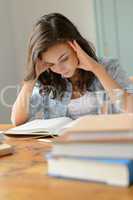 Student teenage girl concentrate reading book home