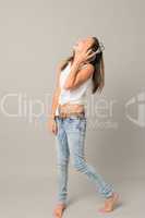 Laughing teenage girl enjoy music from headphones