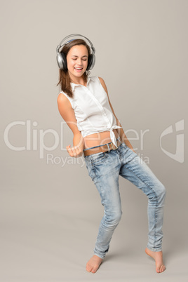 Dancing girl with headphones singing enjoy music