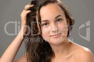 Teenage girl touch wet hair care cosmetics