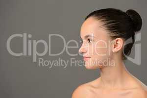 Teenage girl skin care cosmetics looking away