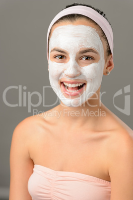 Body care young woman facial mask smiling