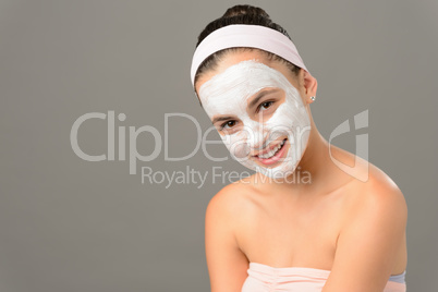 Smiling teenage girl cosmetics mask skin beauty
