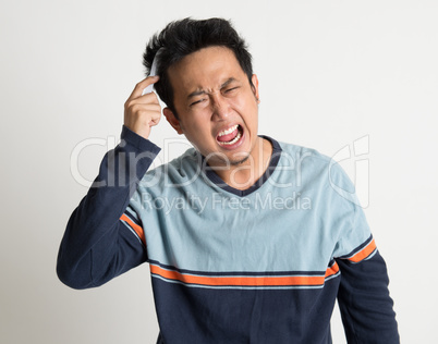 Asian man combing his tangled hair