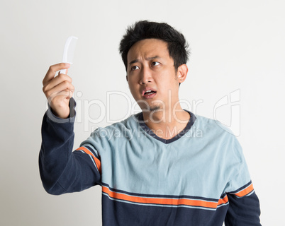 Man checking on a comb with shock face
