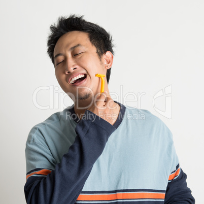 Asian guy shaving his beard