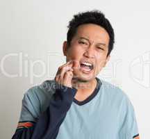 Asian male toothache