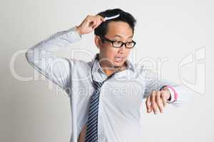 Businessman combing hair in morning in hurry