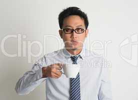 Tired Asian businessman drink coffee