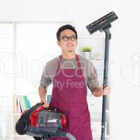 Asian man vacuuming