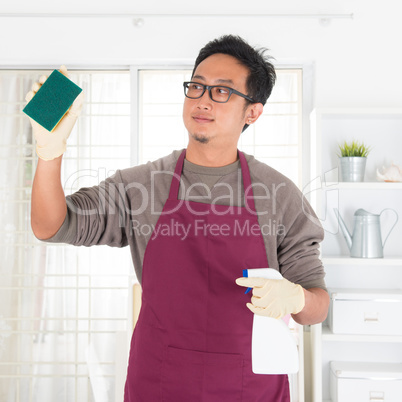 Asian man doing house chores