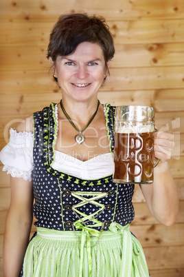 Woman in dirndl with beer mug