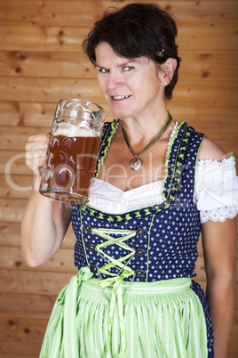 Woman in dirndl with beer mug