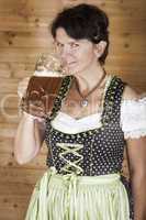 Woman in dirndl with beer mug