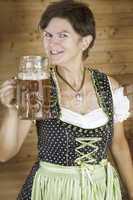 Woman in dirndl with beer mug