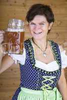 Woman in dirndl with beer mug