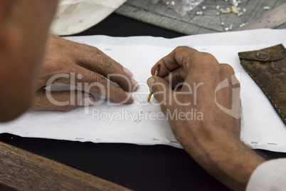 Worker drawing stencil motif on cloth