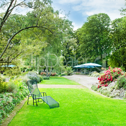 beautiful summer park with green lawns and flower beds