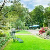 beautiful summer park with green lawns and flower beds