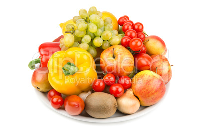 fruits and vegetables on a plate isolated on white background