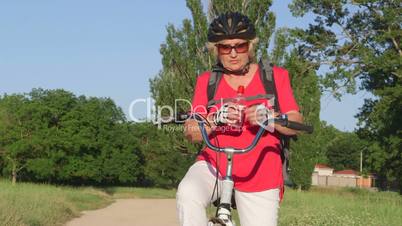 Active senior woman cyclist on bicycle