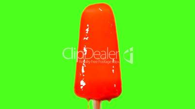 Red ice cream melting on a green background