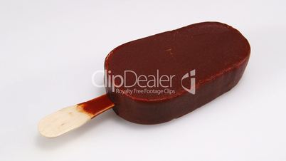 Time-lapse: Chocolate ice-cream melting on white background