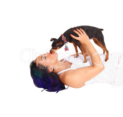 Woman kissing her dog.