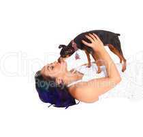 Woman kissing her dog.