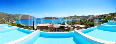 Panorama of swimming pools at luxury hotel with a view on Spinal