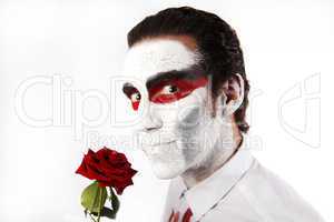 Man with white mascara and red rose