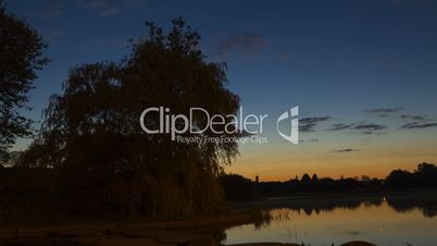 Dawn over the river in the city park