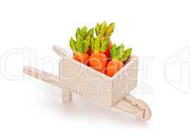 orange toy carrot in a wooden shopping cart  with Clipping Path