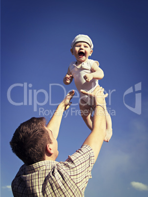 Father tossing baby in the air