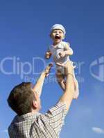 Father tossing baby in the air
