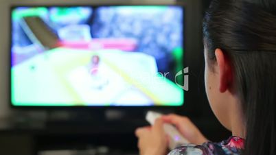 Teenage girl playing video games on smart TV