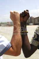 Handshake between a Caucasian and an African