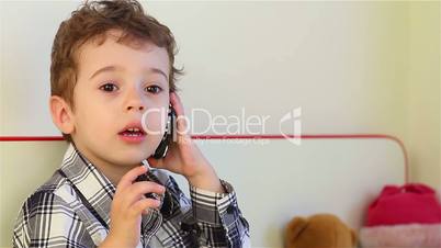 Little boy talking on the smartphone 2