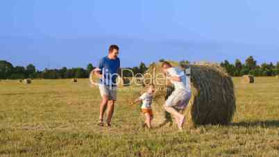 Parents and son playing together in the field